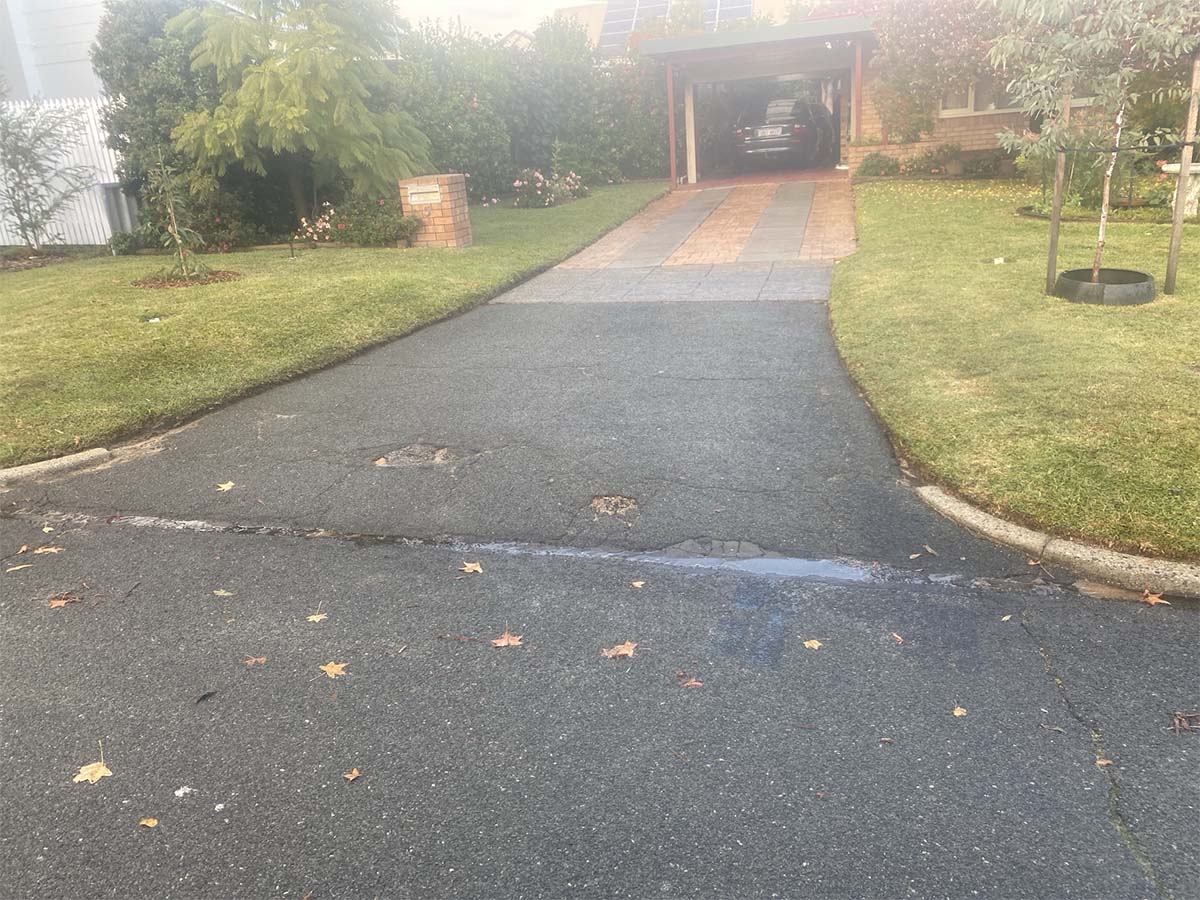 Before image of a asphalt driveway crossover resheet in St James, Western Australia for a private customer.